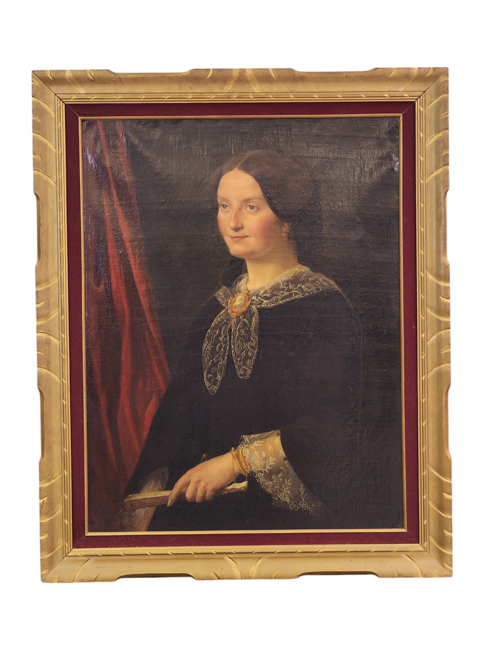 PORTRAIT OF A LADY: Probably American, mid-19th century, oil on canvas. Half-length portrait of a lovely woman, wearing lace and a cameo, and holding a fan. In a period frame. 36.5" high, 27.75" wide (sight); 45" high, 3