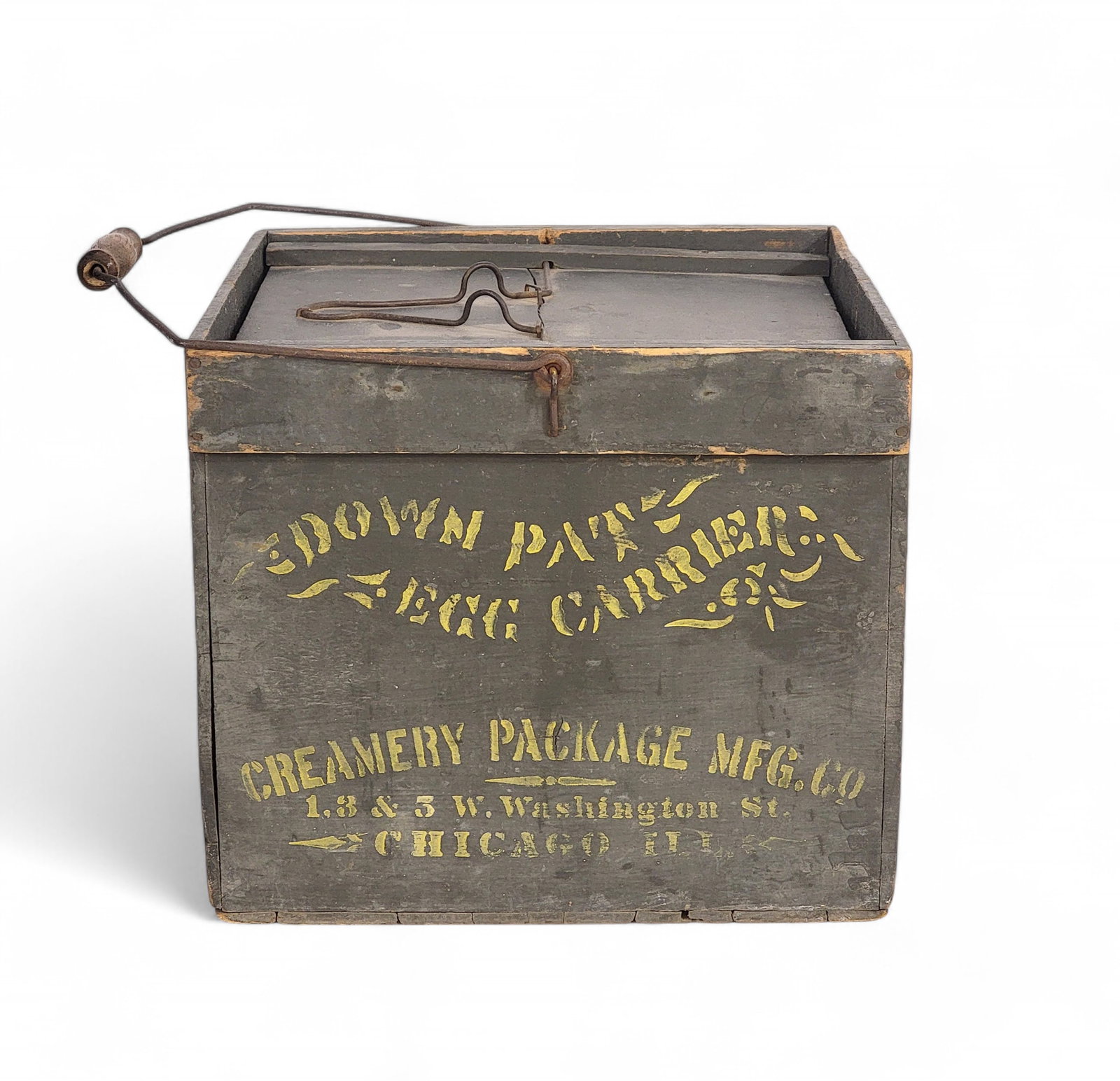 DOWN PATENT EGG CARRIER: Creamery Packaging Mfg. Co., Chicago, Illinois, late 19th century. Original yellow stencil on dark green ground. 10.5" high, 12.5" wide, 12.5" deep.Provenance: private collection.