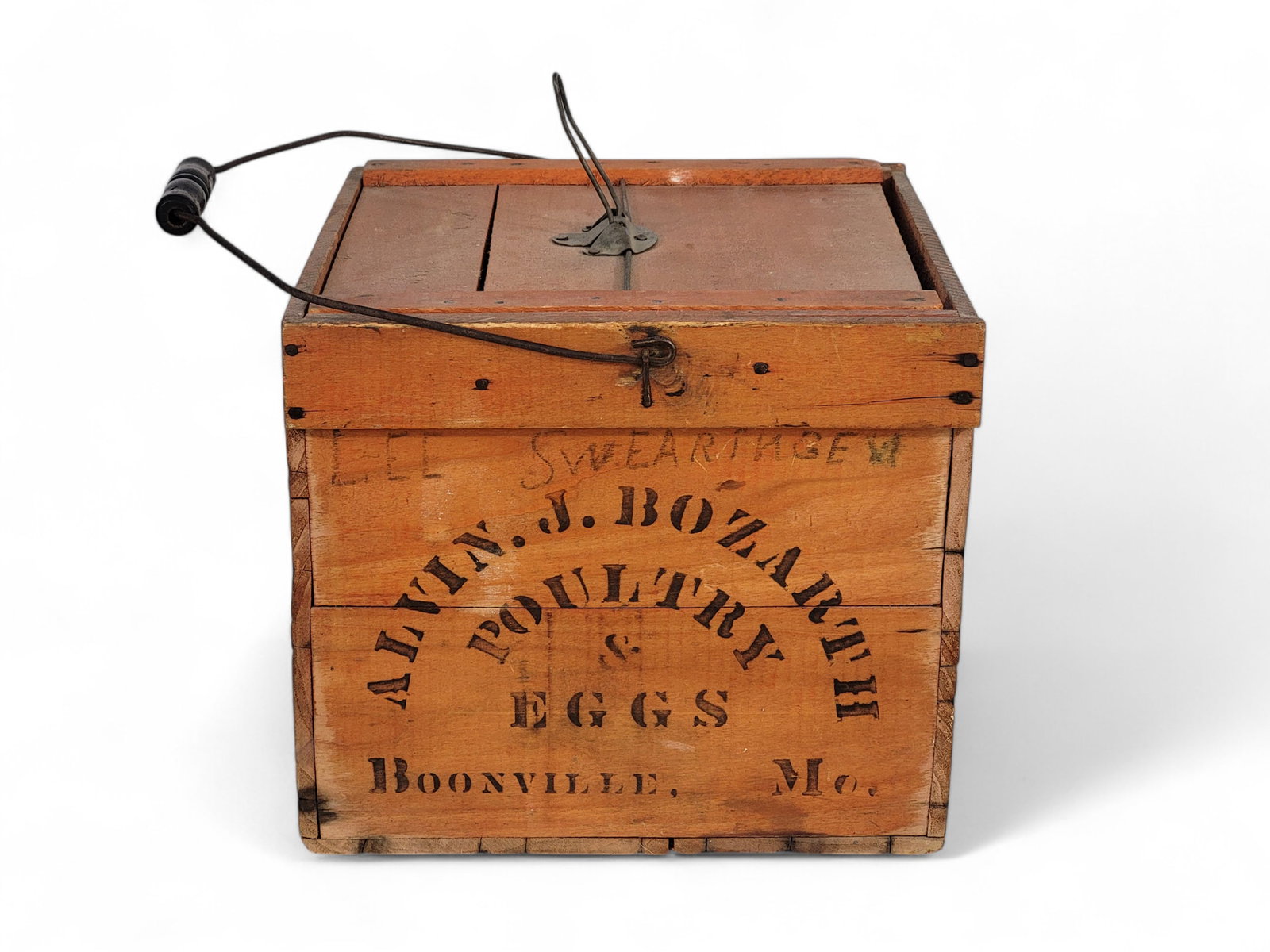 BOONVILLE, MISSOURI EGG CARRIER: Alvin J. Bozarth Poultry and Eggs, late 19th century. With black stenciled decoration on two sides, inscribed on two sides "Lee Swearingen," on salmon ground. Includes egg trays. 10.75" high, 13.5" wi