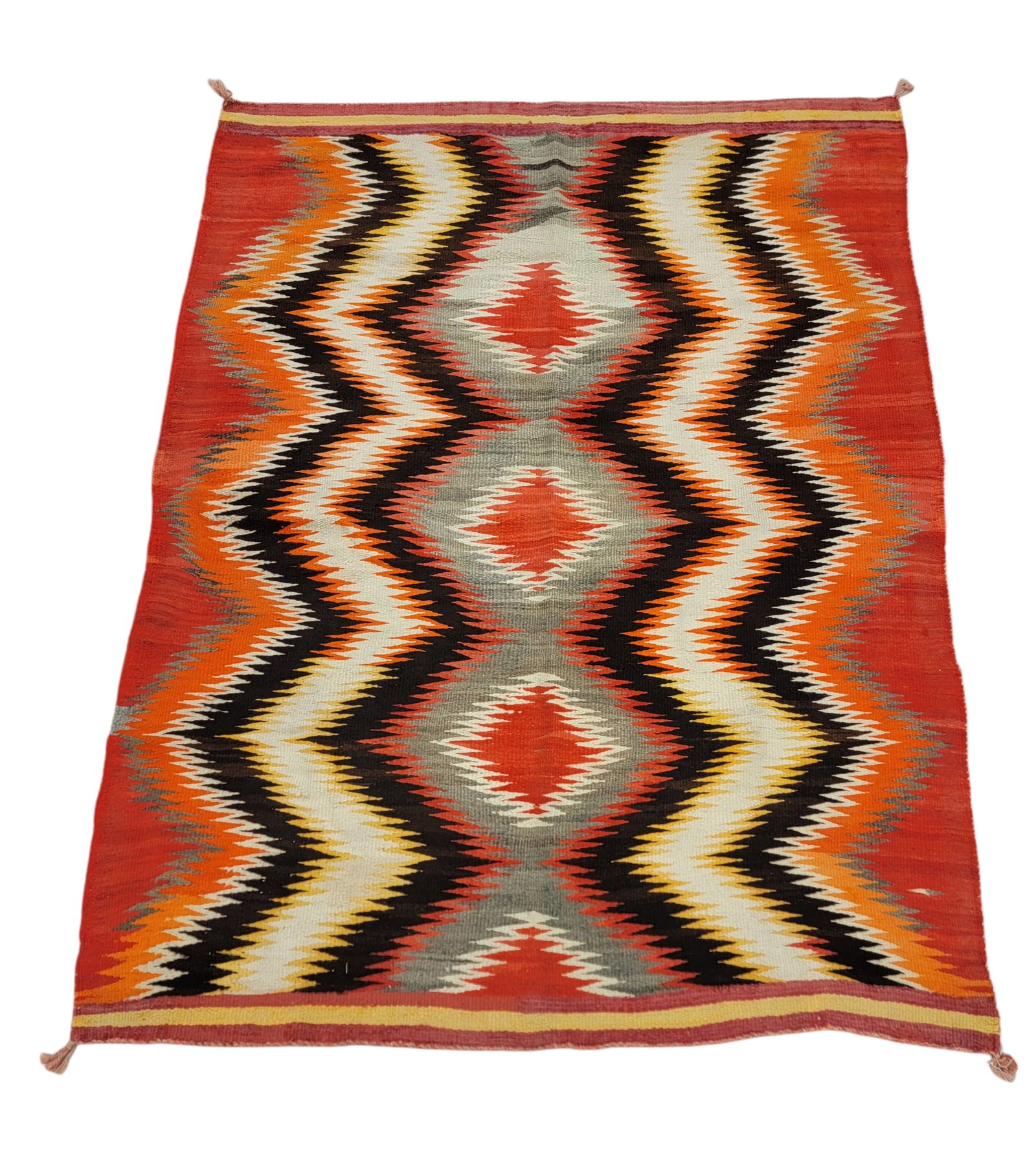 NAVAJO BLANKET: Zig-zag pattern in red, orange, and brown. 80" by 59.5". Provenance: From the Lifetime Collection of a Northeast Ohio Dealer