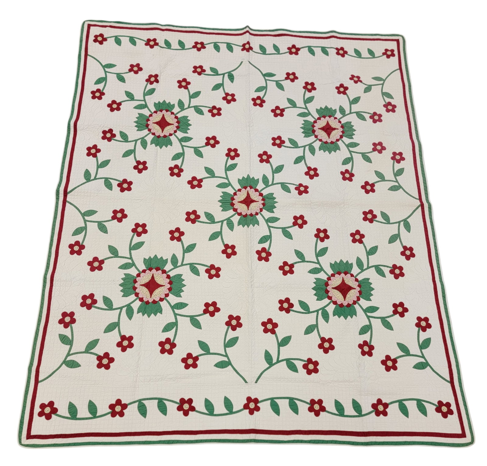 FLORAL APPLIQUE QUILT: American, mid-19th century, cotton. Five floral medallions and a vining floral border along the top and bottom with a thin rectangular border of red and green, the flowers in red, green, pink, and yel