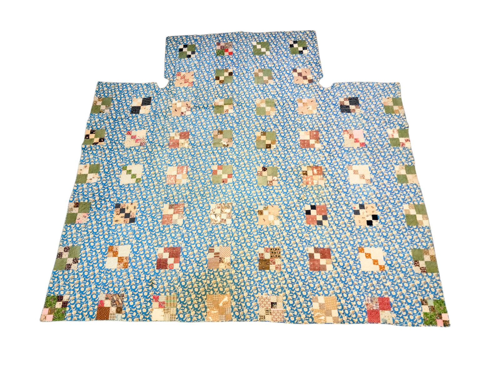 EARLY PIECED QUILT: American, mid-19th century, cotton. Pieced squares on a blue floral ground, with post cut-outs, 99.5" by 102.5". Provenance: The Dr. Virginia Gunn Collection, Wooster, Ohio.