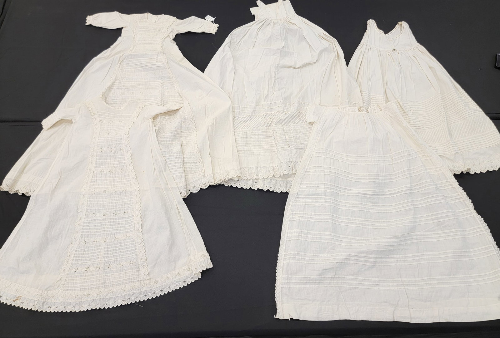 GROUP OF WHITE PLEATWORK GARMENTS: American, late 19th-early 20th century. Five pieces, including gowns and skirts, all with elaborate sewn pleats. Longest skirt is 39" long. Provenance: The Dr. Virginia Gunn Collection, Wooster, Ohio