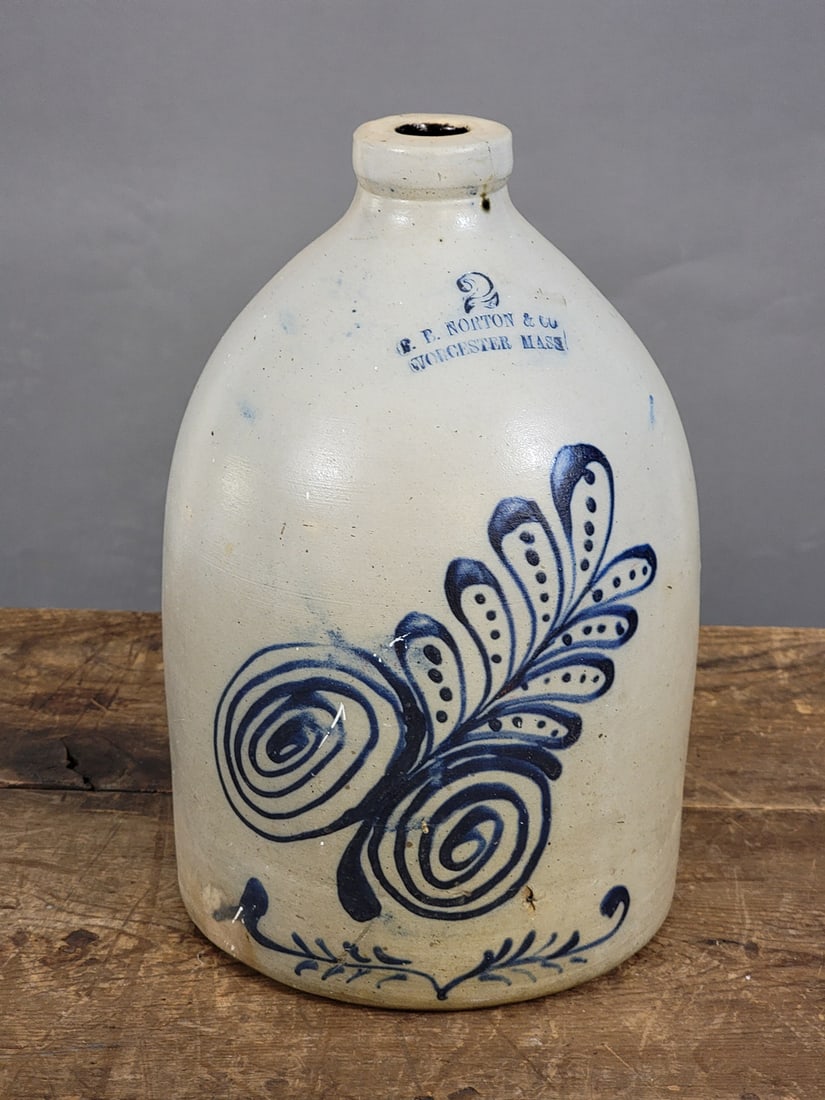 DECORATED STONEWARE JUG: F.B. Norton and Co., Worcester, Massachusetts, 1860-1880. Two-gallon jug with cobalt leaves. 13" high. Provenance: a western New York collection.