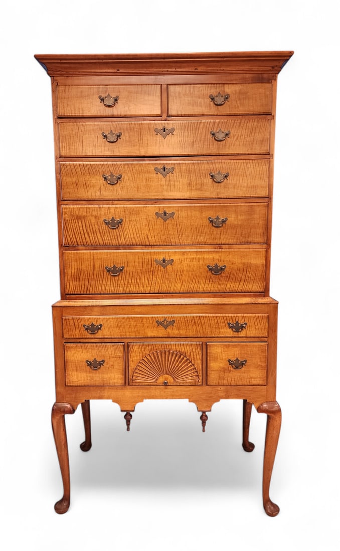 QUEEN ANNE HIGH CHEST OF DRAWERS: New England, mid-18th century, curly maple and pine. Two-piece (associated); the upper section with a flat top and two over four drawers; the lower case with one over three drawers (one of which is sh