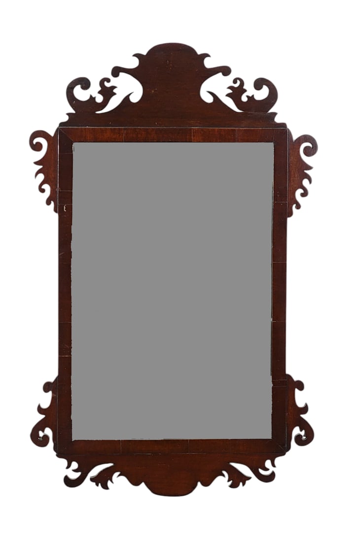 CHIPPENDALE MIRROR: Possibly Irish, late 18th century, mahogany. Of typical form, with a scroll-cut frame. 27.5" high, 17" wide. Provenance: a western New York collection.