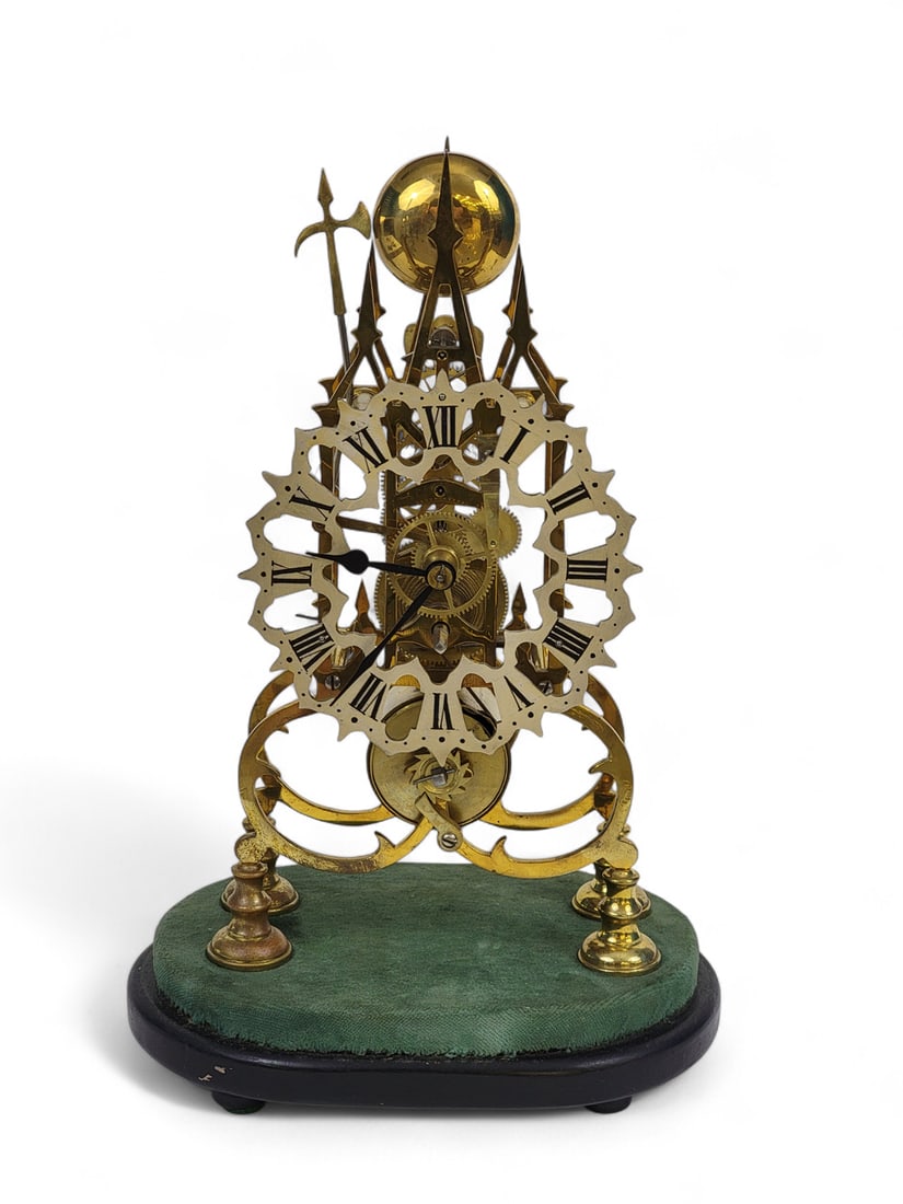 SKELETON CLOCK: European, early 20th century. Brass mantle clock with Roman numeral dial, church steeple designs and axe striker. 15" high, 10" wide, 7" deep.