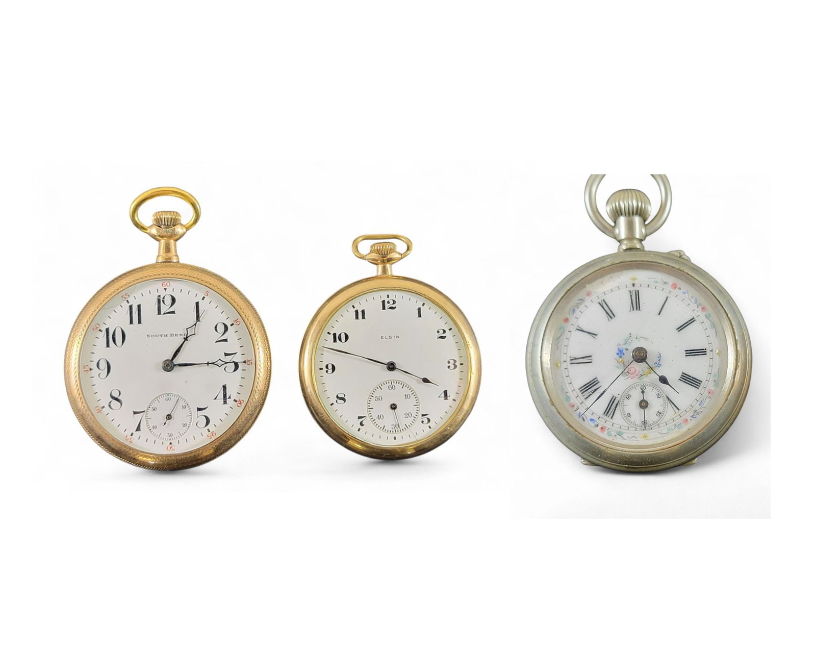 THREE OPEN-FACE POCKET WATCHES: American, c. 1920. One Elgin, size 10, gold-filled case. 1.75" diameter. One South Bend, size 16, 19 jewel movement, gold-filled case. 2" diameter. One in a silver-tone open face case with handpainted