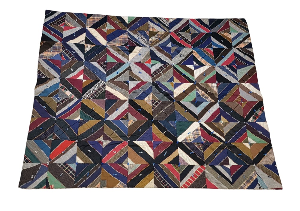 PATCHWORK CRAZY QUILT: American, cotton. A pieced and tied crazy quilt with 90 blocks and hand embroidered details, paisley print backing, 71" by 65". Provenance: The Virginia Gunn Collection, Wooster, Ohio.