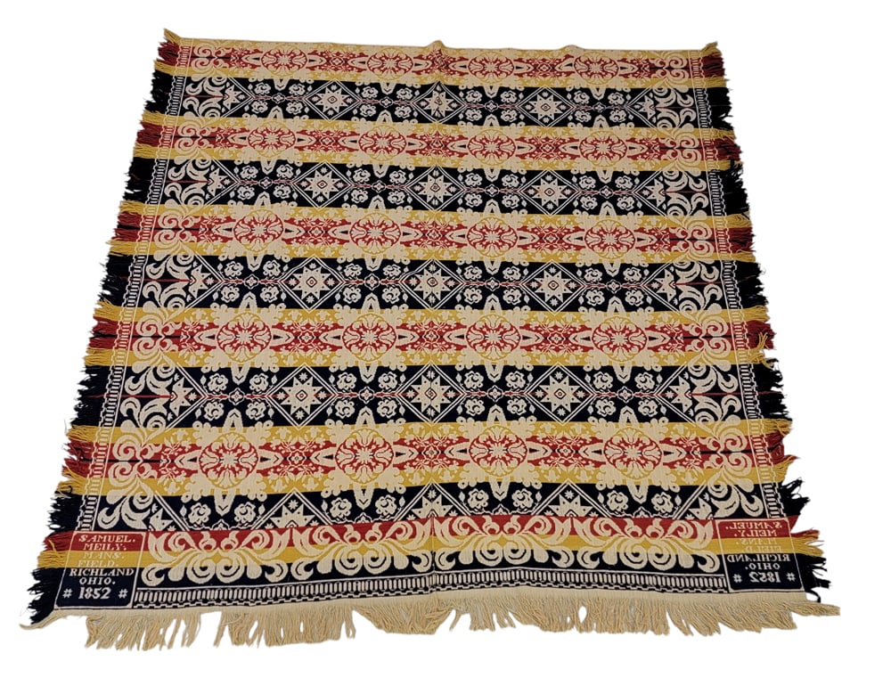 MANSFIELD (RICHLAND COUNTY), OHIO COVERLET: Samuel Meily, Sr., Richland County, 1852. A coverlet in red, gold, and blue with a centerfield of floral medallions and offset eight-point stars, foliate borders, corner blocks signed and dated "SAMUE