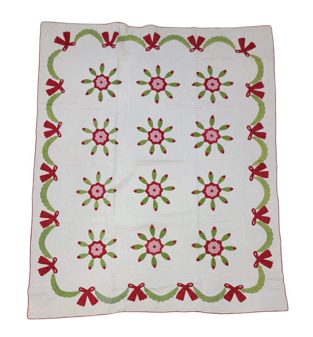 EAST LIVERPOOL, OHIO APPLIQUE QUILT: East Liverpool, Ohio, cotton. A quilt with red, green, and pink floral medallion appliques of a central bloom surrounded by eight buds and green swag borders with red bows, red binding, 87" by 72". Pr