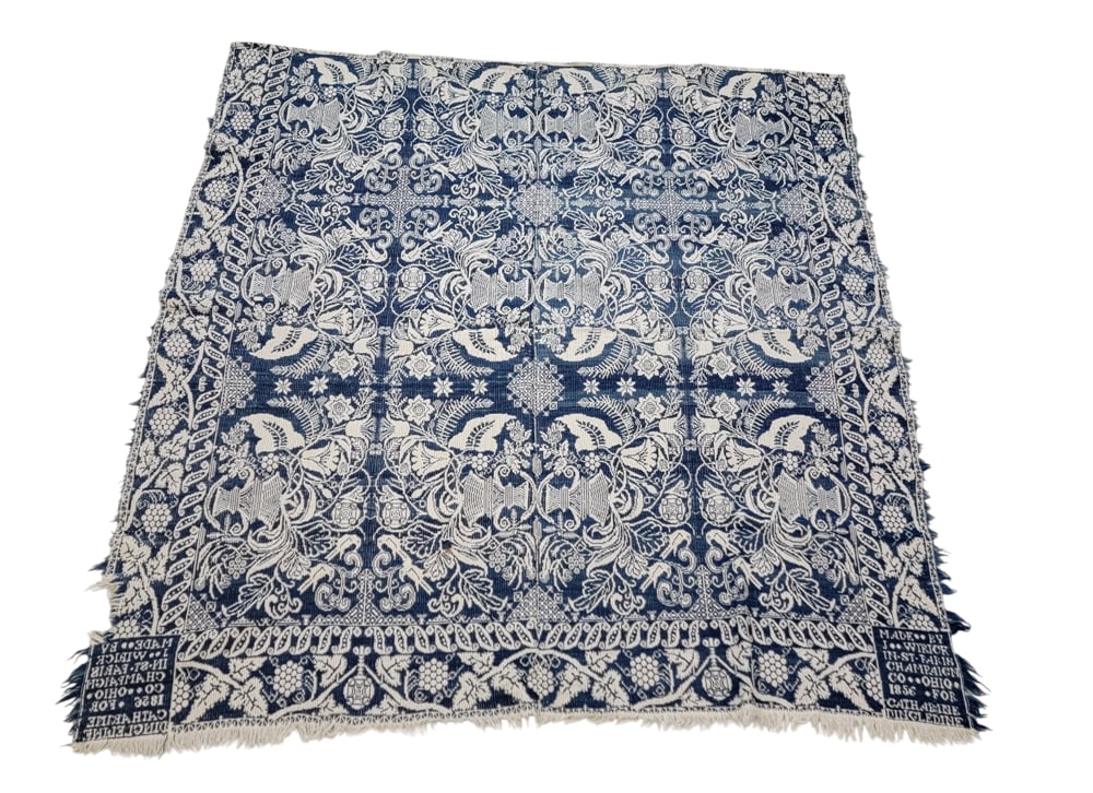 ST. PARIS (CHAMPAIGN COUNTY), OHIO COVERLET: John Wirick, Champaign County, 1856. A coverlet in blue and white with a centerfield of floral urns, grapevine borders, corner blocks inscribed "MADE BY J. WIRICK IN ST. PARIS CHAMPAIGN CO. OHIO 1856 