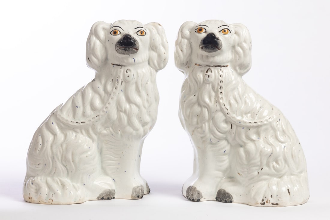 PAIR OF STAFFORDSHIRE SPANIELS: England, late 19th century. White, with enameled and gilt accents. 10" high. Provenance: the collection of the late Jo Louise Brown, Zoar, Ohio. In-house shipping is available for this lot. Please see