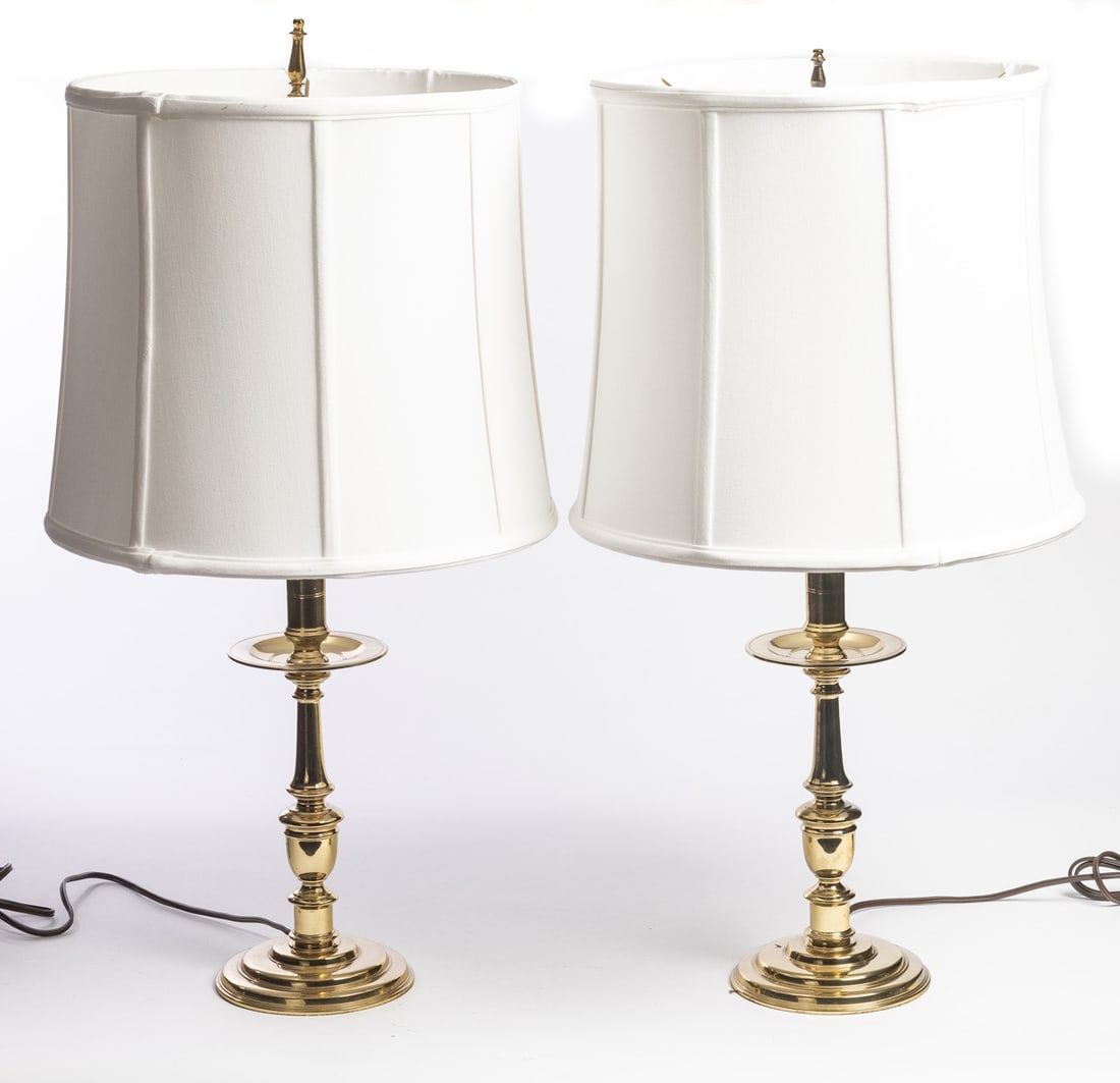 PAIR OF VIRGINIA METALCRAFTERS LAMPS: Brass, with drip pans and silk shades. 25.5" high (overall). Provenance: the collection of the late Jo Louise Brown, Zoar, Ohio. In-house shipping is available for this lot. Please see our terms for d