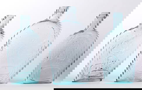 THREE HISTORICAL GLASS FLASKS: Mid-19th century. All aqua, includes a Union/Clasped Hands, 8.5" high; together with a Cunningham, Pittsburgh, Pennsylvania eagle, 8" high; and a eagle/Pike's Peak, 7.75" high. Provenance: the collect