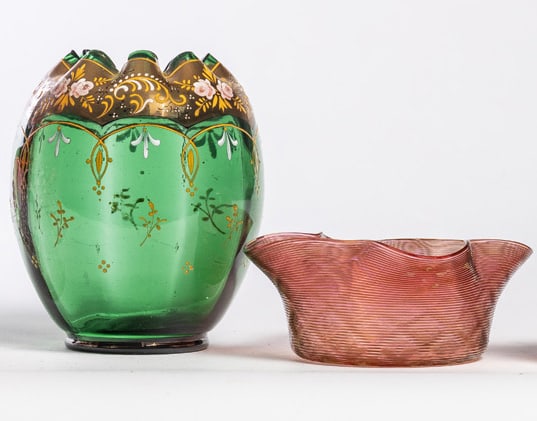 TWO PIECES ART GLASS: Late 19th-early 20th century. Includes a green vase with gilt and enameled decoration, 6" high; together with a pink ruffled and threaded bowl, 6" diameter. Provenance: the collection of the late Jo L