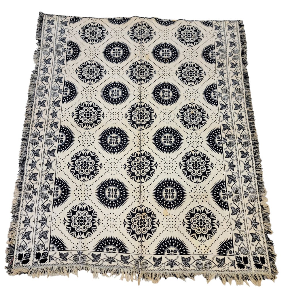 SCIOTO COUNTY, OHIO COVERLET: Attributed to Portsmouth, Scioto County, Ohio, mid-19th century. A coverlet in dark blue with floral and compass medallions in a dotted lattice with grapevine borders and small floral corner blocks. 8