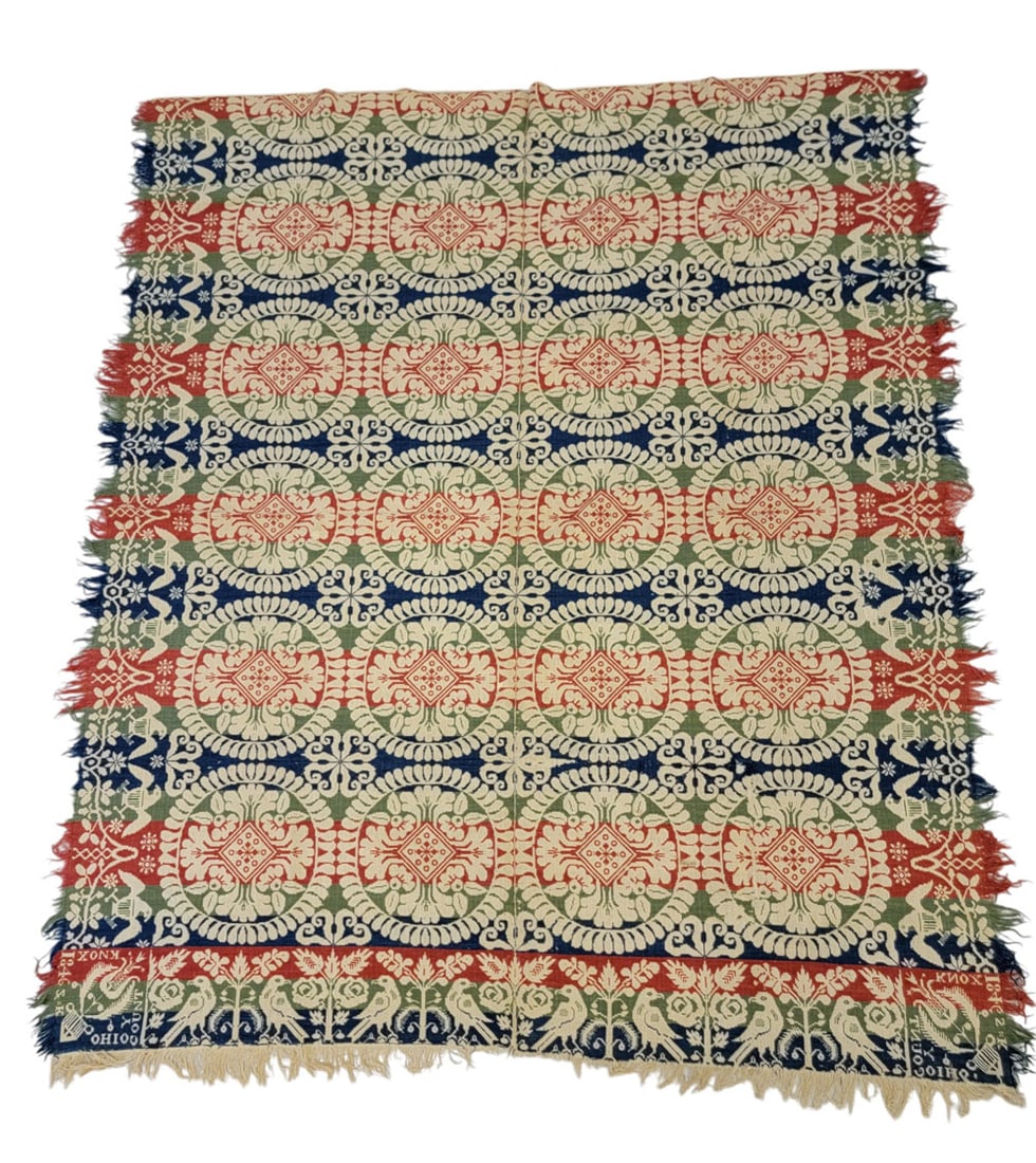 KNOX COUNTY, OHIO COVERLET: Ohio, 1846. A coverlet in red, green, and blue with foliate wreaths and curling leaf medallions, with eagle side borders and a bird and rosebush foot border, and corner blocks with a tulip signed "S K