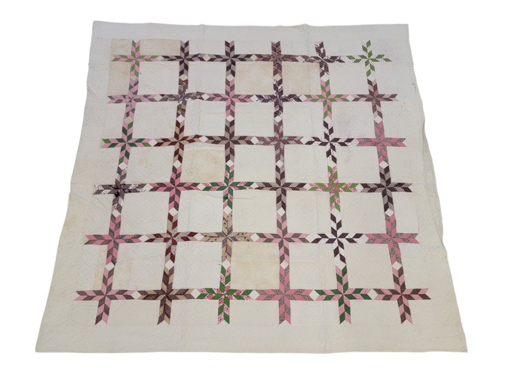 OHIO PIECED QUILT: Ohio, 19th century, cotton. A pieced and handstitched quilt in printed fabrics in shades of pink, brown, and green, the cross designs forming a grid. 82.5" by 79". Provenance: The Virginia Gunn Collec