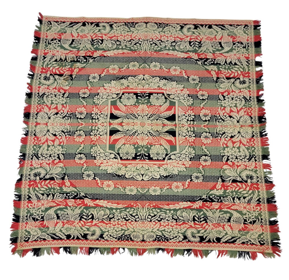 JACQUARD COVERLET: American, mid-19th century. A coverlet in red, blue, and green with a large floral medallion at the center, surrounded by a border and floral wreaths, with a wide floral border and large birds in the 
