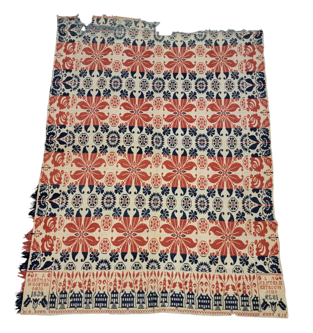 WAYNE COUNTY, OHIO COVERLET: Ohio, 1839. A coverlet in red and blue with primary curling leaf designs and offset twenty-four point rosettes, rose side borders, house and steeple foot border, and corner block signed and dated with