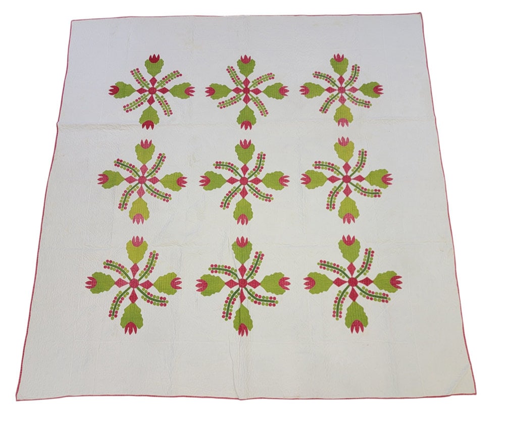 COXCOMB AND CURRANTS APPLIQUE QUILT: American, 19th century, cotton. A handstitched quilt with nine coxcomb and currant appliques in red and green, with red binding. 86" by 86". Provenance: The Virginia Gunn Collection, Wooster, Ohio. Dr