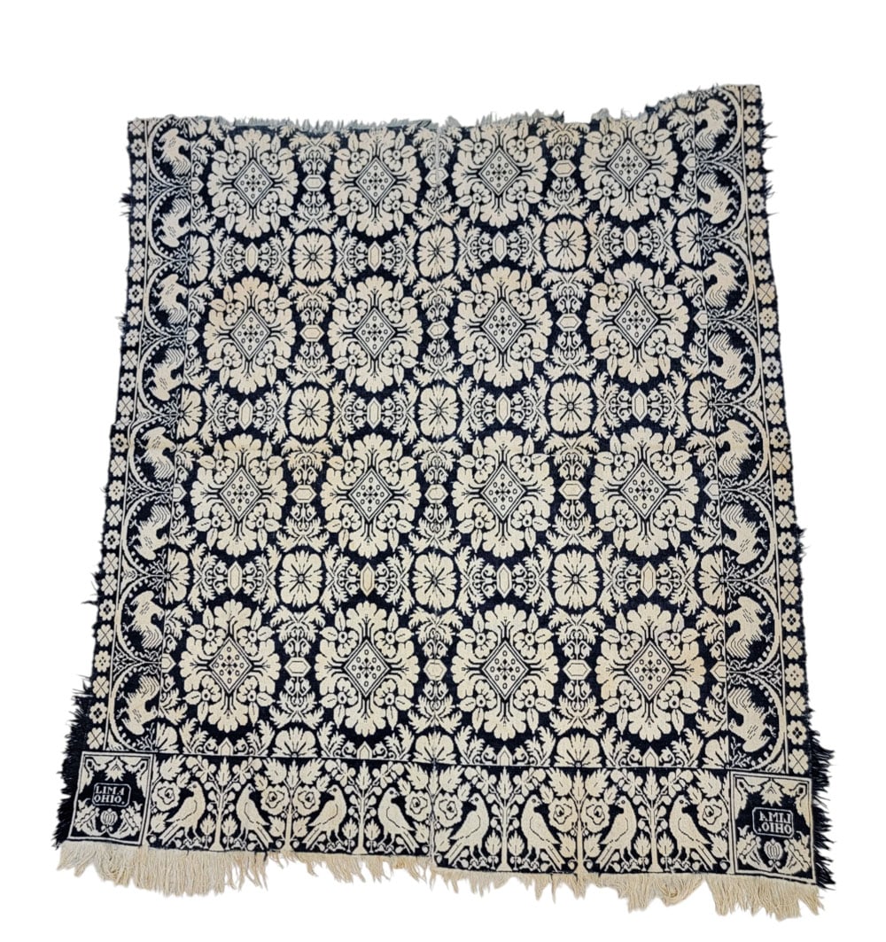 ALLEN COUNTY, OHIO COVERLET: Ohio, mid-19th century. A coverlet in dark blue and white with floral and foliate medallions, side borders of roosters over swags, a bird and rose foot border, and foliate corner blocks inscribed "LIM