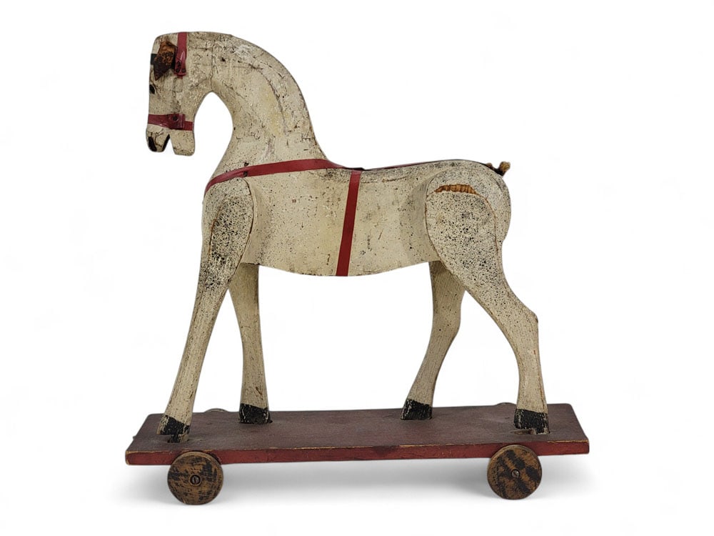FOLK ART HORSE PULL TOY: Late 19th-early 20th century. Original paint. 14" high, 14" long. Provenance: an Ohio collection. Affordable, in-house shipping is available for this lot. Please contact us for a quote.