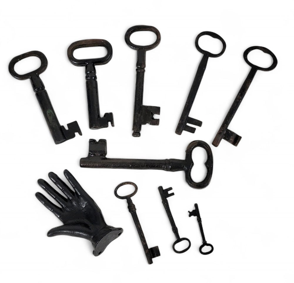 COLLECTION OF EARLY KEYS: 19th century and earlier, cast iron. Longest is 7". Together with a cast-iron hand, possibly a finial. Provenance: a southern Ohio collection.