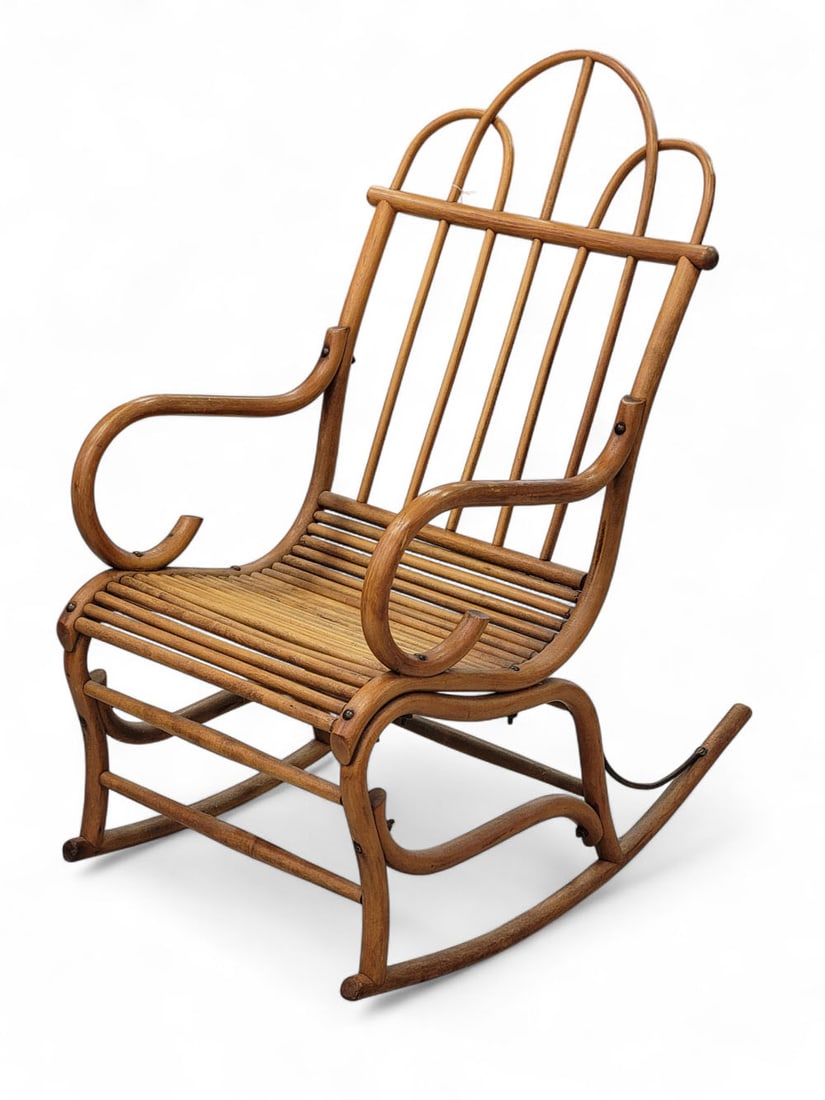 FOLKSY BENTWOOD ROCKING CHAIR: Illinois, late 19th. Triple-arched back creating seven splats. Scrolled arms, seat composed of side-by-side horizontal dowels. 41" high. Provenance: from a Midwestern collection. Pickup or freight shi