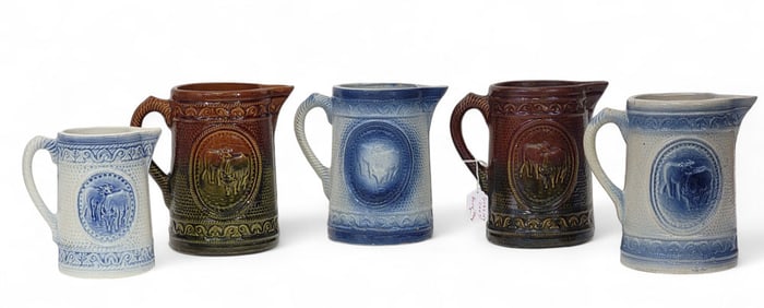 FIVE MOLDED PITCHERS WITH "GRAZING COWS"