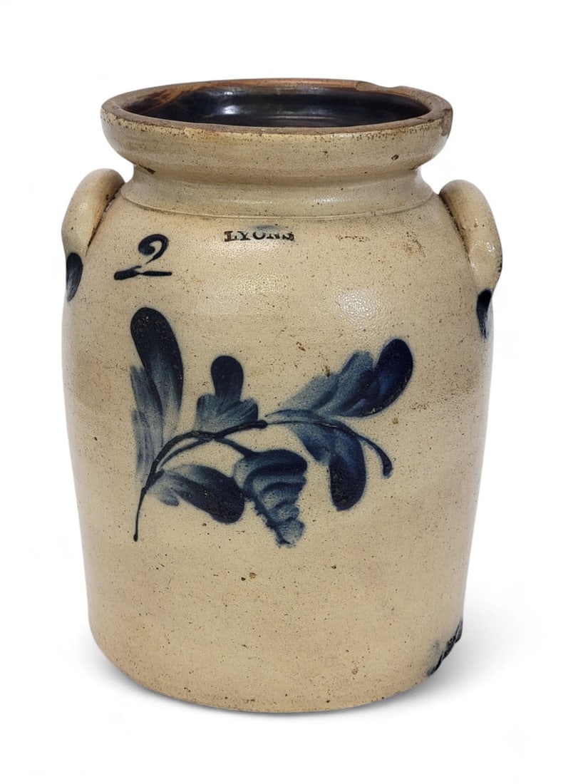LYONS TWO-GALLON COBALT-DECORATED STONEWARE CROCK: New York, mid-19th century. Salt-glazed stoneware crock with applied handle, tooled shoulder, and wide lip. Cobalt-decorated flower and cobalt brushmarks where handles applied to shoulder and where th