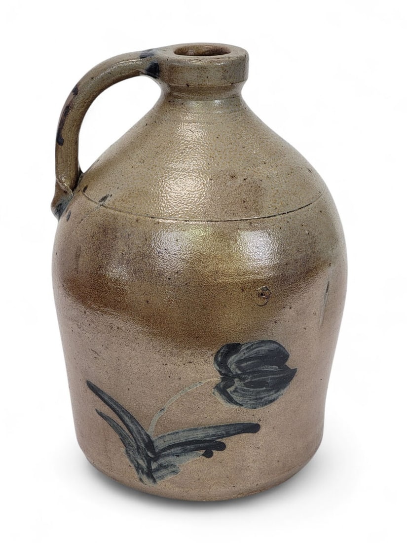 ONE-GALLON STONEWARE JUG WITH TULIP: American, 2nd half-19th century. Salt-glazed stoneware jug with tooled shoulder, drooping tulips brushed in cobalt slip on both sides, cobalt highlighting top and base of handle, "1" gallon capacity m