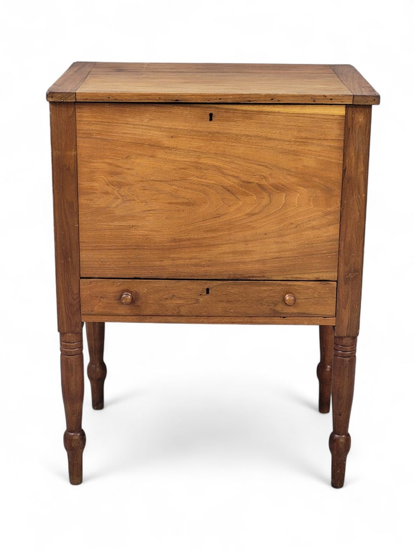 MIDDLE TENNESSEE SUGAR CHEST: 1820-1840, walnut and poplar. Divided interior and high, turned legs, and a lid with breadboard ends. 36" high, 26.75" wide, 18.75" deep. Provenance: a Midwestern collector Pickup or freight shipping