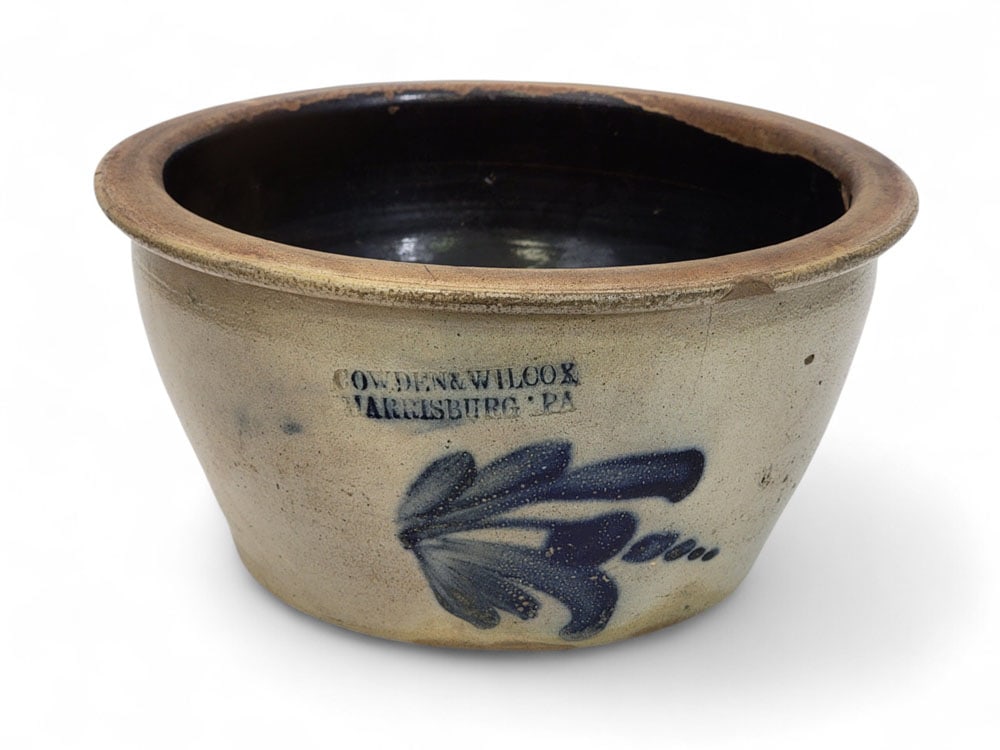 COWDEN & WILCOX, HARRISBURG STONEWARE BOWL: Pennsylvania, 2nd half-19th century. Wide, salt-glazed stoneware bowl, ovoid shape with narrow flat rim. Cobalt brushed foxglove flower decoration, stamped "COWDER & WILCOX / HARRISBURG PA". No capaci