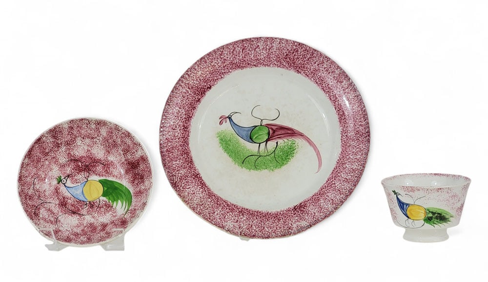 RED SPATTERWARE PEAFOWL PLATE & CUP/SAUCER: English, 19th century. Includes a plate, 9.25" diameter; saucer, 6.25" diameter; and cup, 2.75" high. Provenance: an Ohio collection. Affordable, in-house shipping is available for this lot. Please co