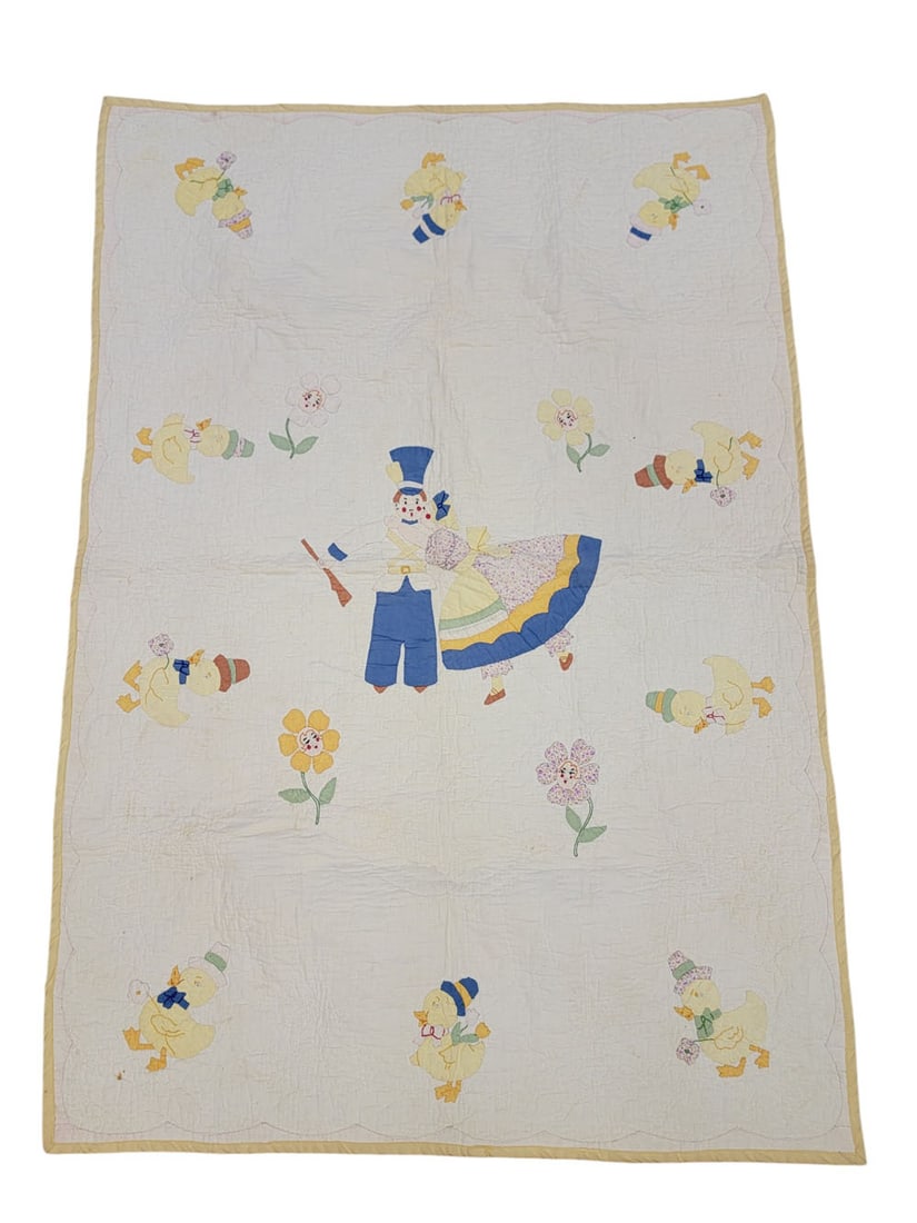 NURSERY CRIB QUILT: American, early 20th century, cotton. Nursery quilt with applique and embroidered figures: girl kissing soldier, ducklings in hats, flowers with faces. Quilted top, yellow border. 39" by 34.25". Prove