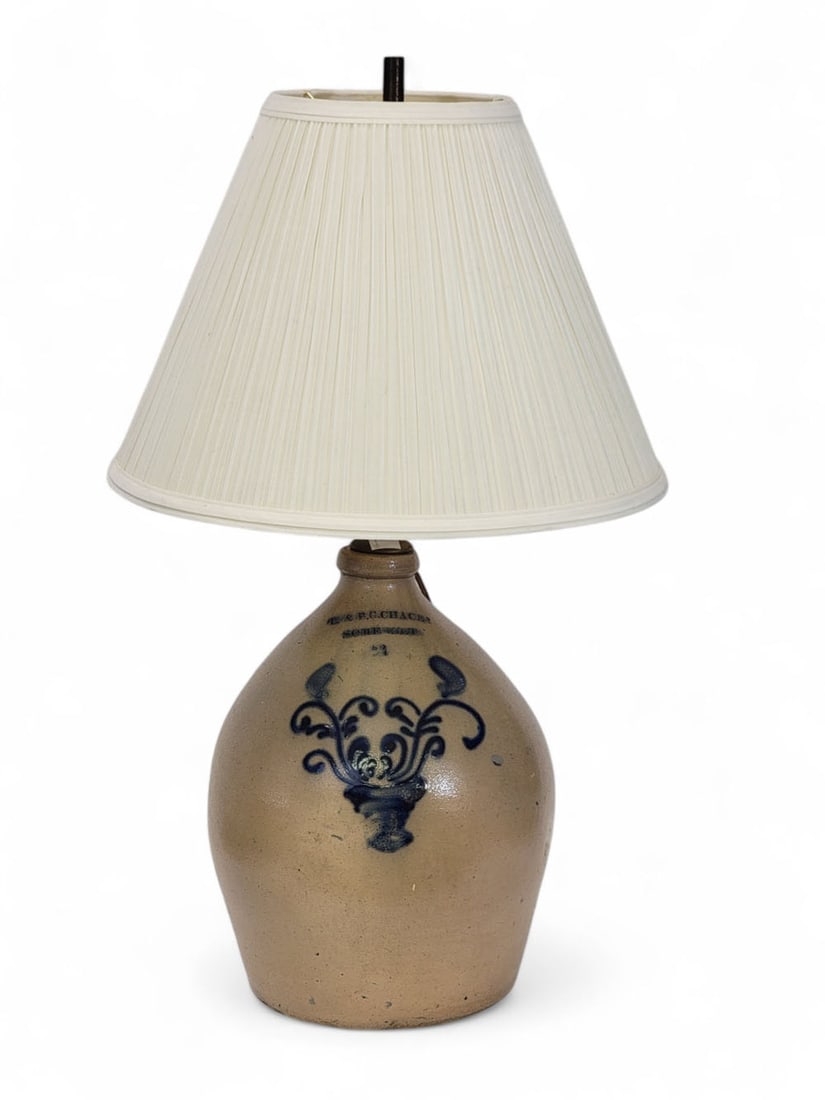 L. & B.G. CHACE SOMERSET COBALT-DECORATED STONEWARE JUG: Massachusetts, mid-19th century. Salt-glazed stoneware jug turned into a lamp. Ovoid body with tooled neck and stamped "L & B.G.CHACE? / SOMERSET / 2". Crisp cobalt slip-trailed design of vase with tw