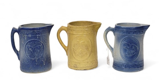 THREE MOLDED PITCHERS WITH WINGED CREATURES