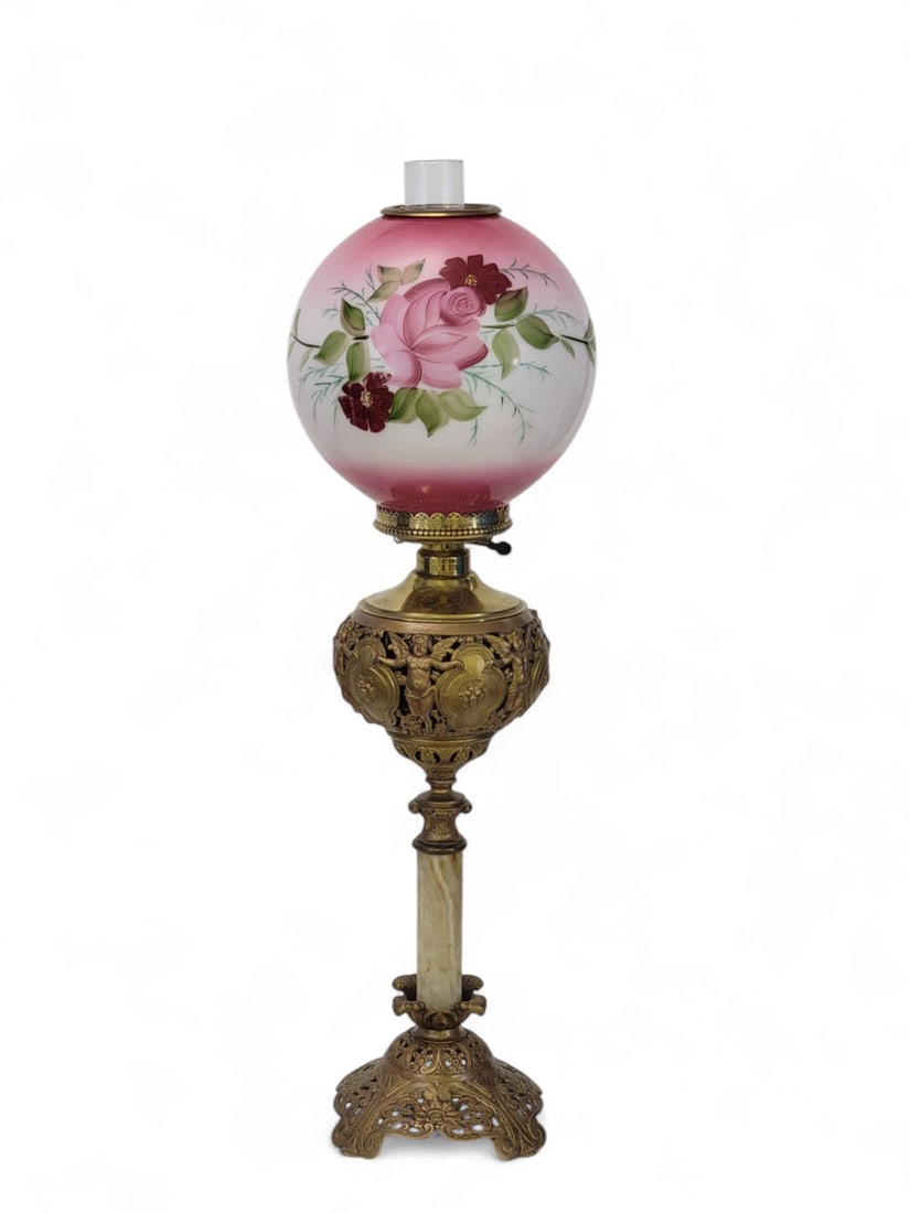 BRADLEY & HUBBARD VICTORIAN BANQUET LAMP: Late 19th century. Victorian "Gone with the Wind" banquet lamp with cast bronzed base, onyx column, figured brass font featuring dancing cupids, and pink and white ball shade with handpainted rosettes