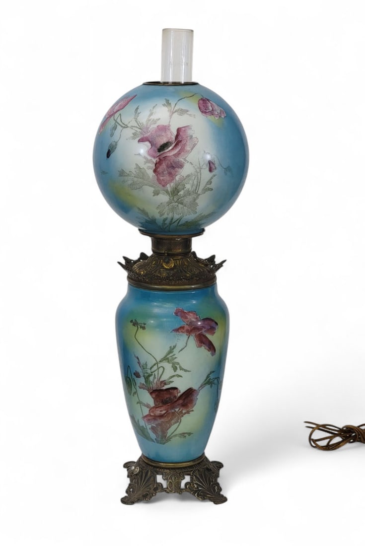 FOSTORIA BANQUET LAMP: Ohio, c. 1900. Fostoria "Gone with the Wind"-style banquet lamp with cast iron base, font, and crown ring with brass finish. Matching decorated ball shade and column with blue, yellow and white ground