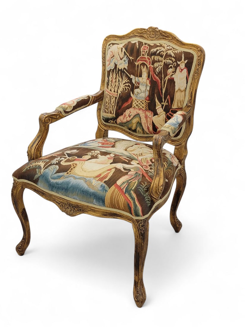 LOUIS XV-STYLE FRENCH FAUTEUIL WITH TAPESTRY UPHOLSTERY: Early 20th century. Armchair with carved flowers and leaves on top rail, apron, and tops of legs. Tapestry is a colorful Chinoiserie scene, brown background. 38" high. From a Columbus, Ohio collection