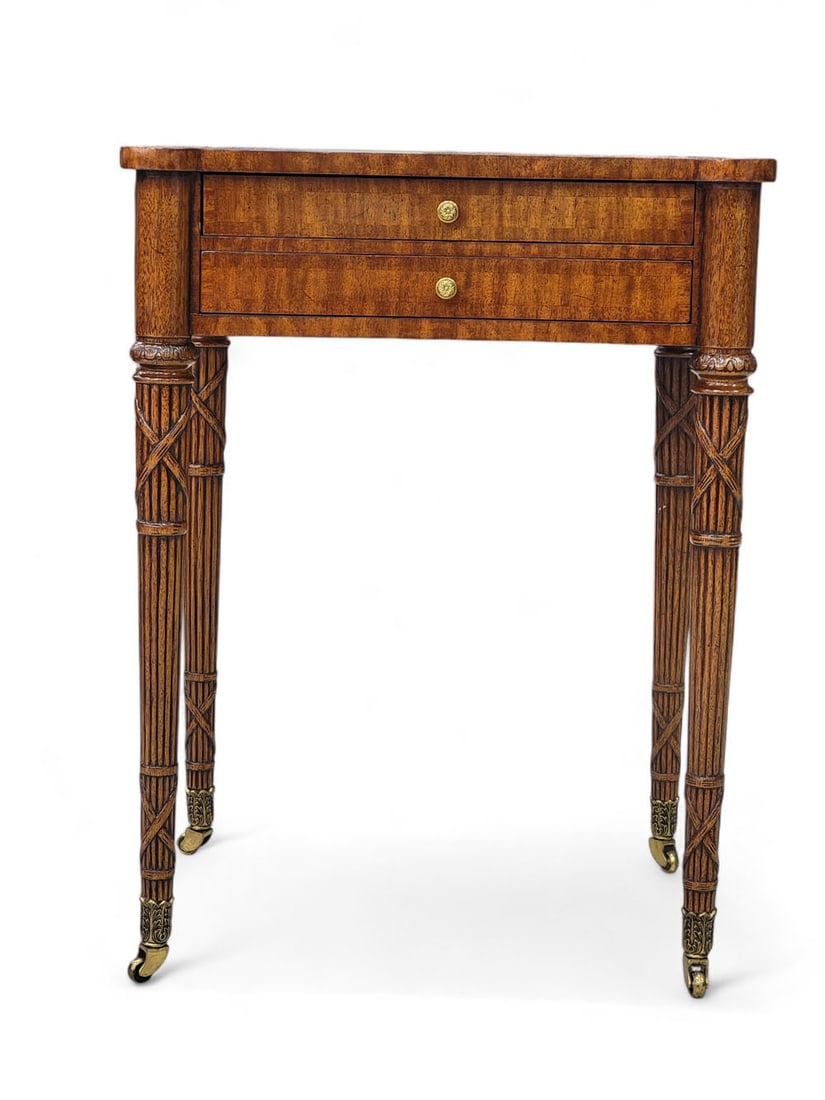 MAITLAND SMITH FEDERAL-STYLE END TABLE: Late 20th/early 21st century. Mahogany veneer with brass hardware and embossed leather surface. Two fitted drawers with brass pulls and crossbanded drawer fronts. Legs are tapered and reeded, with car