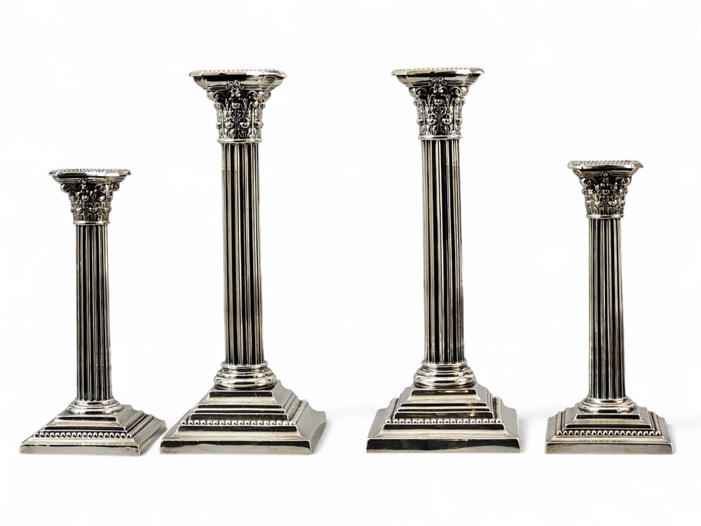 SET OF FOUR NEOCLASSICAL SILVER GORHAM CANDLESTICKS: 20th century. Corinthian column form. Bottoms of smaller pair stamped "Shreve, Crump & Low Co," and bear Birmingham town mark and Gorham company mark, 7.25" high. Larger pair also marked for Gorham an