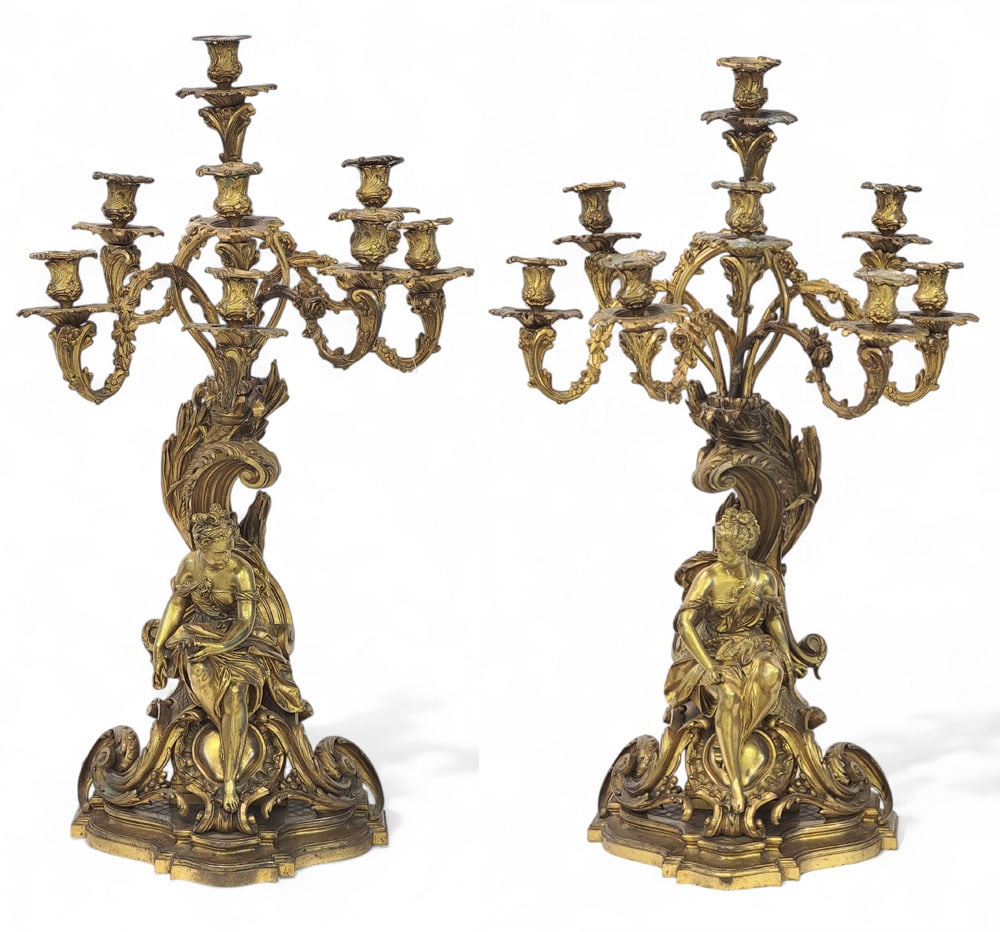 PAIR OF MONUMENTAL GILT BRONZE CANDELABRA: French, late 19th century. Large pair of gilt bronze eight-light candelabras in the French Rococo style with rocaille motifs supporting two seated Classical female figures beneath (likely Athena and B