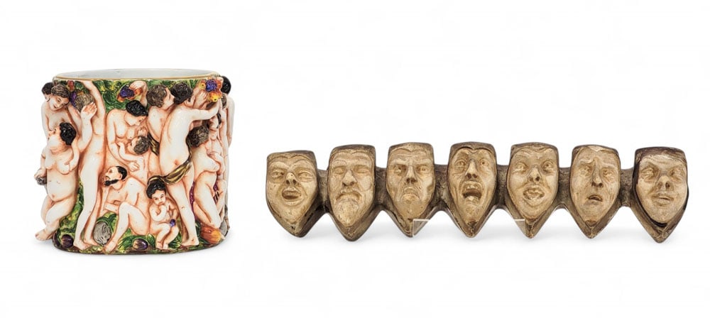 CAPODIMONTE VASE AND WALL ORNAMENT: European, late 19th century. Includes a porcelain Capodimonte vase with nude figures, 5.5" high; together with a painted plaster wall ornament featuring seven faces, possible the Seven Deadly Sins, 13