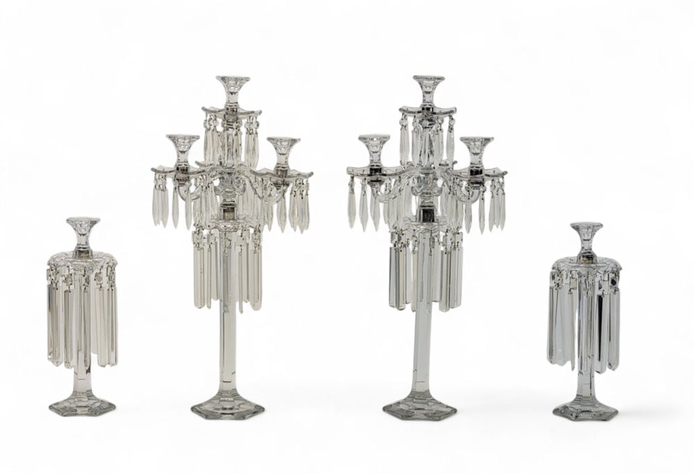 SUITE OF HEISEY CANDLE HOLDERS: Newark, Ohio, 2nd quarter-20th century. Includes a pair of large pressed-glass candelabras with 11 parts each. Four capitals (three below and one above). Hexagonal base and bobeches, multiple tiers of