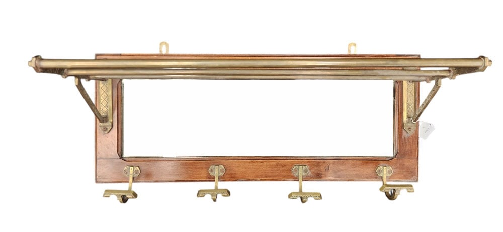 TRAIN MIRROR AND WICKER SUITCASE: American, early 20th century.Pullman train car hat rack with mirror (11" high, 27.25" wide, 10"deep) and wicker suitcase (11" high, 14.5" wide, 4.5"deep). Hat rack has wooden wall-mounted frame with a