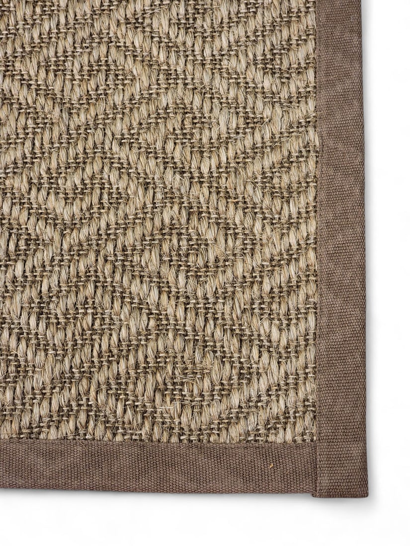 ROOM-SIZE JUTE/SISAL RUG: 21st century, with Greek key pattern. Brown canvas border, lined on bottom.142" by 106". From a Columbus, Ohio collection. Pickup or freight shipping is required for this lot. Please see our terms for