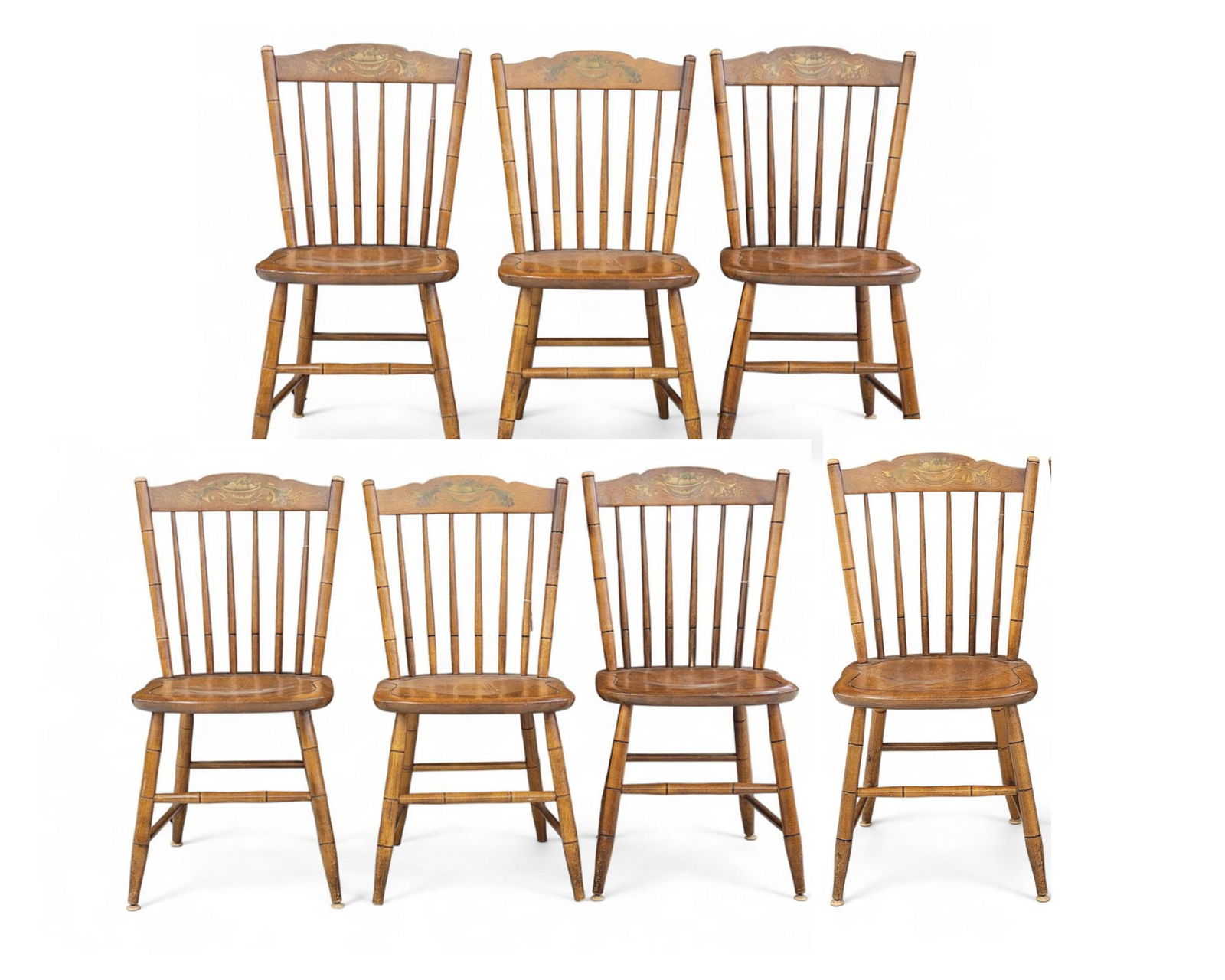 SET OF SEVEN HITICHCOCK WINDSOR CHAIRS.: Connecticut, c. 1948, maple. Set of seven Windsor dining chairs with gold-painted fruit bowl scene on crest rail. Posts, spindles, legs, and front stretcher with bamboo turnings. Back of seat stamped